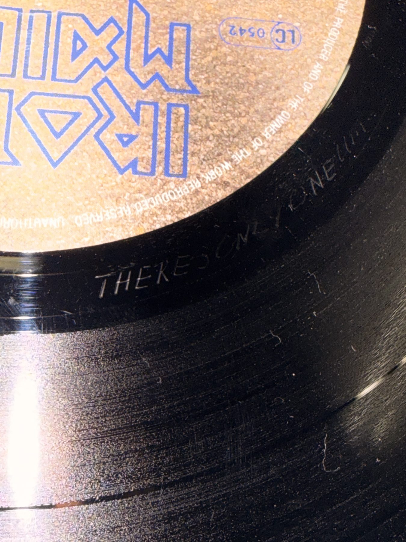 The run-out groove of folder 108, with THERE'S ONLY ONE scratched into the blank vinyl
